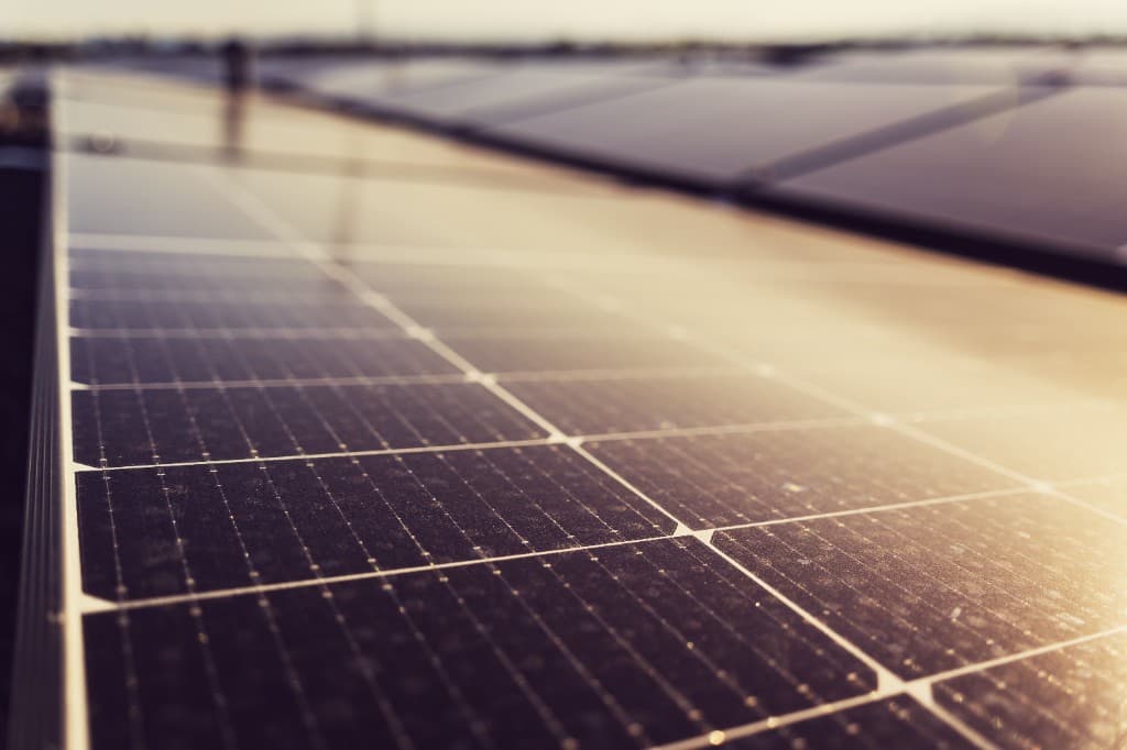 Close-up of a solar panel array at golden hour in a large-scale solar farm, illustrating Maharashtra's MSKVY 2.0 feeder solarisation scheme